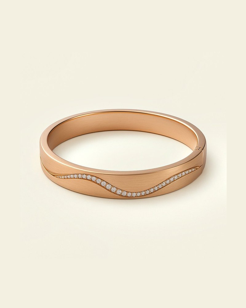 Design render of the Fil bracelet in rose gold: a bangle with a fine wave line running along its front.