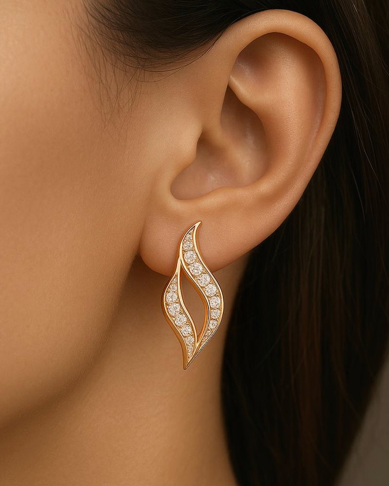 Design render of an open, flame-shaped rose gold earring worn on the ear.